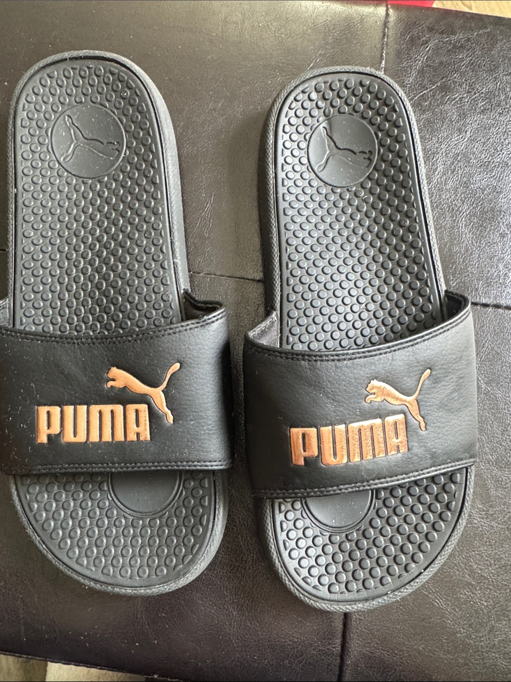 Puma Kids Black Slides with Gold Logo